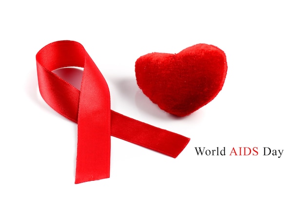 Aids ribbon and heart on white background.