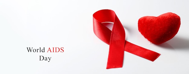 Aids ribbon and heart on white background.