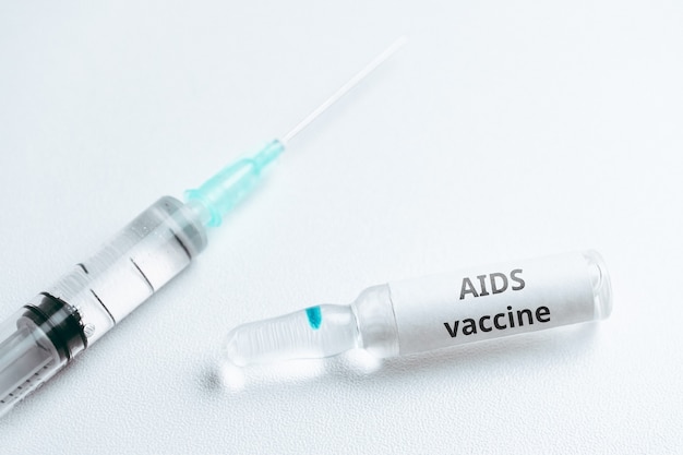 AIDS vaccine concept in ampoule and syringe.