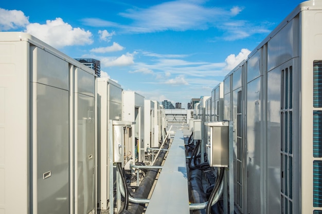 Premium Photo | Air compressor on roof of factory with blue sky background