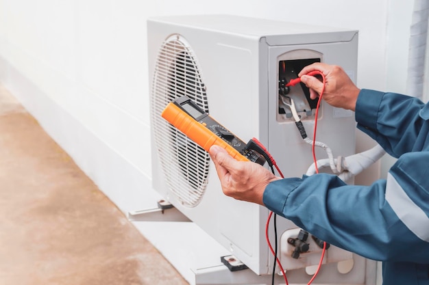 Air conditioner technician checking air conditioner operation.