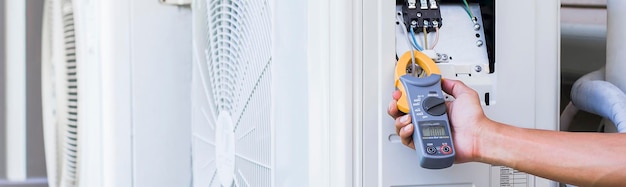 Air conditioner technician checking air conditioner operation.