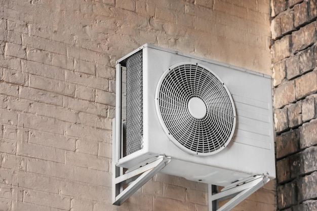 Air conditioner on wall of building outdoors