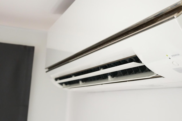 Air conditioner on white wall room interior background