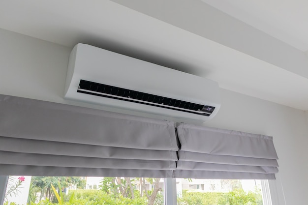 Air conditioner on white wall room interior background