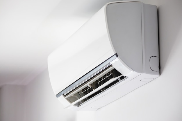 Air conditioner on white wall room interior background