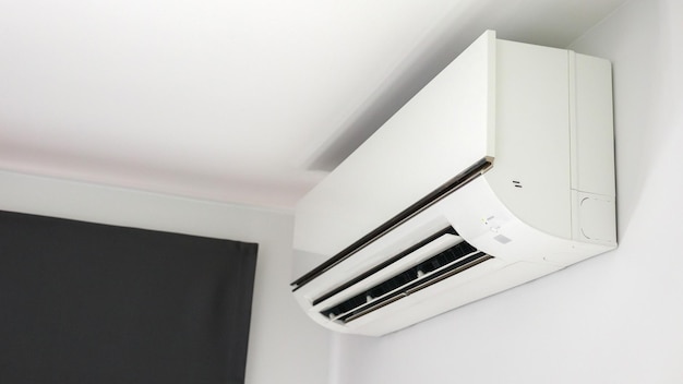 Air conditioner on white wall room interior background