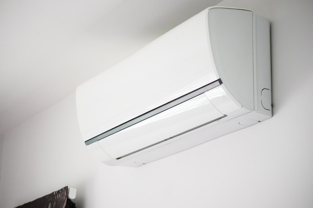 Air conditioner on white wall room interior