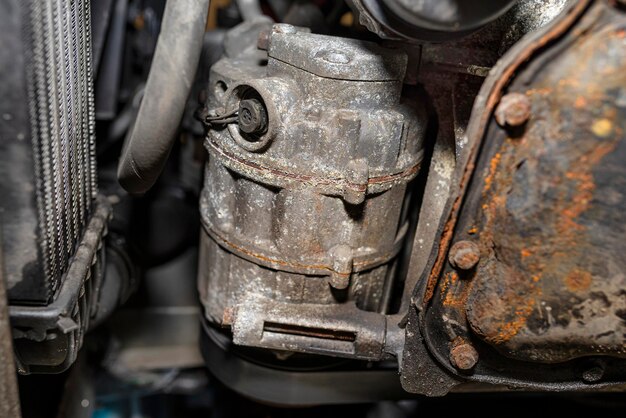 Air conditioning compressor in a passenger car seen from below