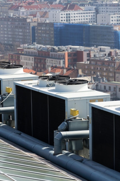 Photo air conditioning ventilators on roof with houses in background