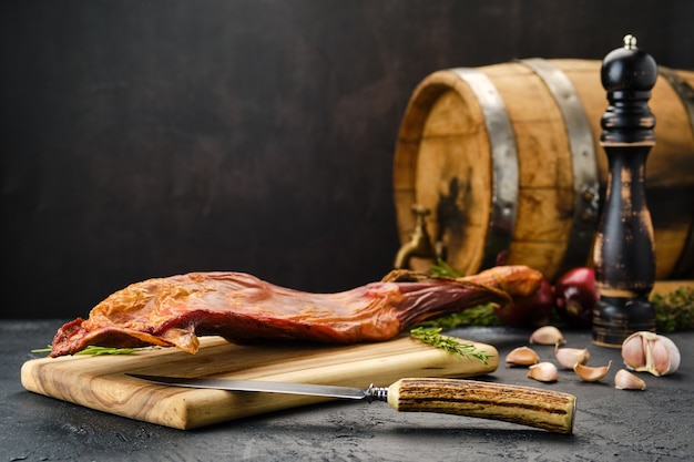 Air dried lamb meat on wooden cutting board