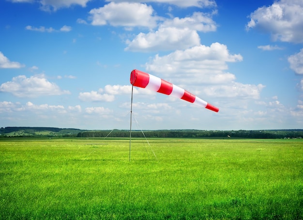 Air field direction sign and a wind force against the dark blue sky