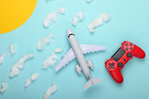 Air game. Gamepad, toy plane on a of the sunny sky with clouds