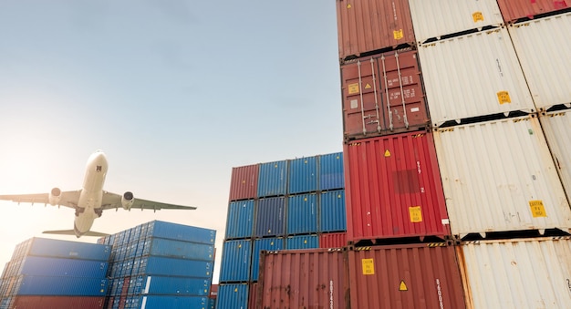 Air logistics Cargo airplane flying above stack of logistic container Cargo and shipping business