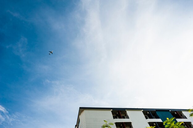 air plane at sky and part of building 