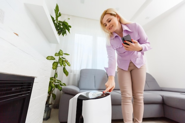 Air purifier , Business woman use filter for clean room in a living room