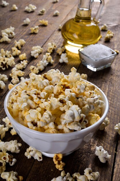 Air salty popcorn.A bowl of popcorn on a wooden table.Salt popcorn on the wooden table .