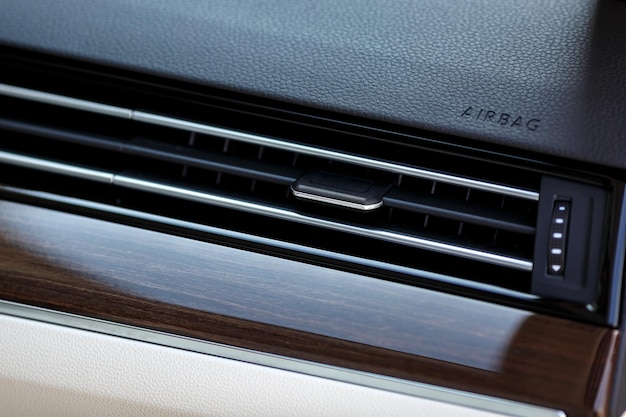 Air vent grill in luxury car. ar air conditioner, buttons, display.