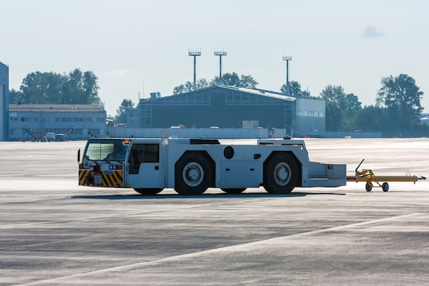 Aircraft tow tractor with moving tug on the airport apron