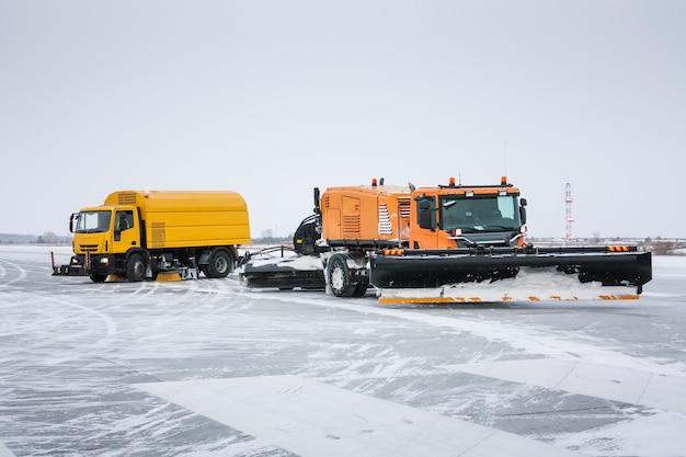 Airfield sweeper-vacuum machine and snowblower universal cleaning truck on the winter runway