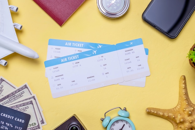 Airline tickets and accessories for travel and vacations on a yellow background