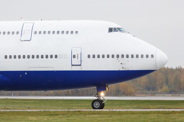 Airplane on airport runway against sky