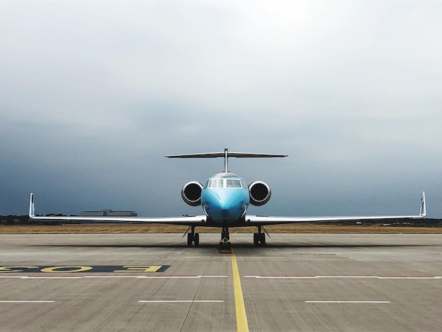 airplane on airport runway against sky
