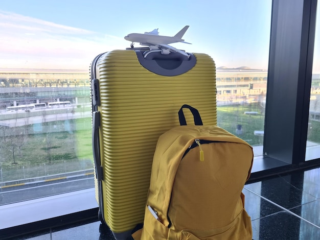 Airplane backpack suitcase in airport departure hall