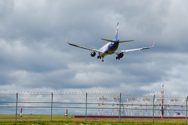 Airplane on a blue sky in the clouds