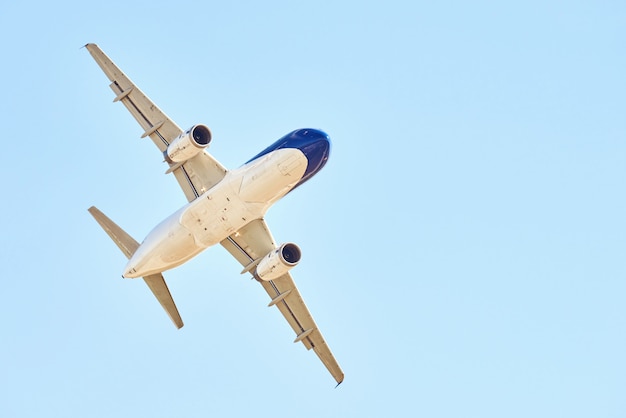 Airplane over blue sky