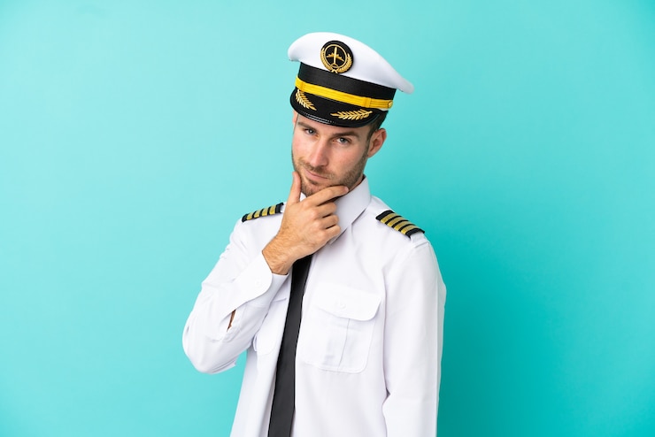 Photo airplane caucasian pilot isolated on blue background smiling