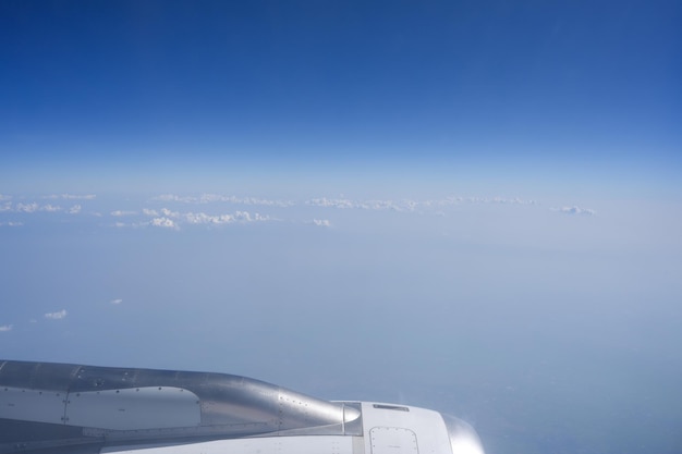 Airplane engine against cloudy blue sky background