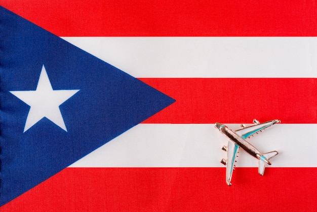 Airplane over the flag of Puerto Rico travel concept