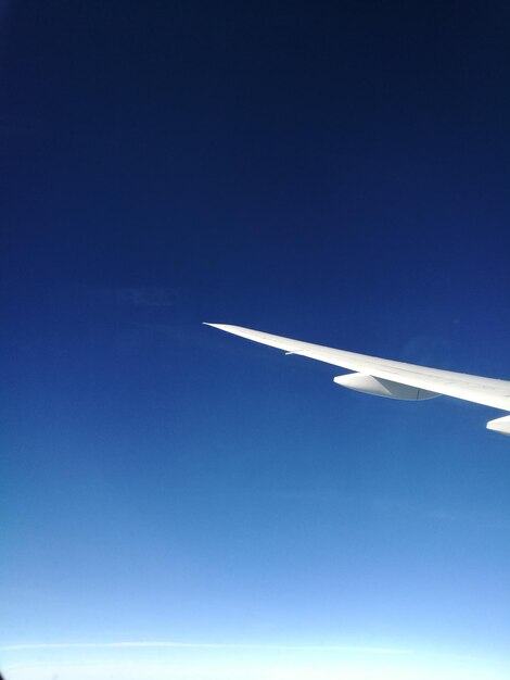 Airplane flying against clear blue sky