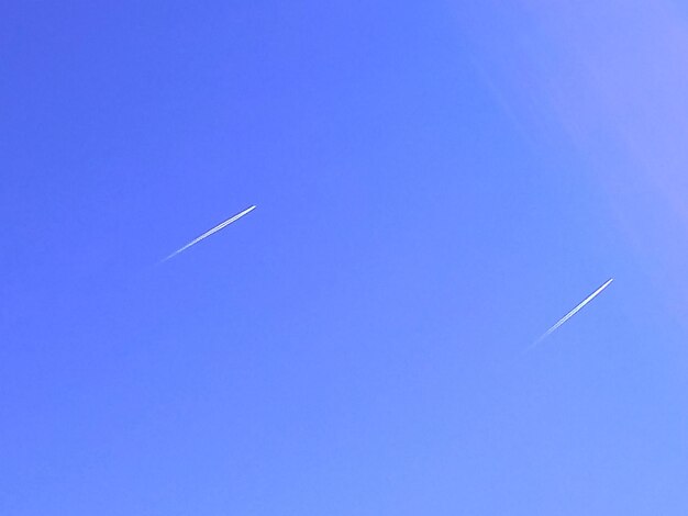 Airplane flying against clear blue sky