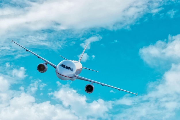 Airplane flying in blue sky with clouds. Travel and transportation concept.