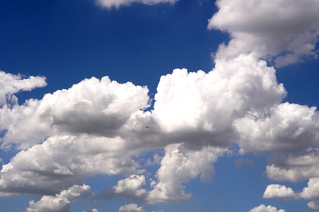 Airplane flying over the clouds in the blue sky backgrounds