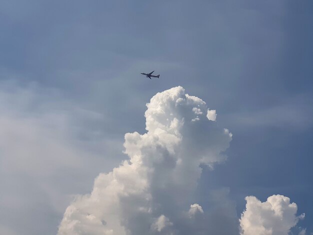 Airplane flying over the clouds in the sky backgrounds