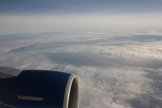 Airplane flying over cloudscape against sky