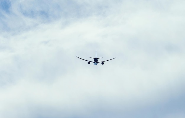 Airplane Flying Through Cloudy Sky