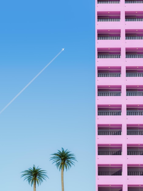 Airplane Flying Over Tropical Palm Trees and Pink Apartments Building