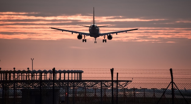 Airplane landing with sunset