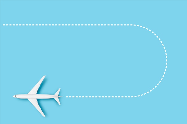 Airplane and line indicating the route on a blue background. Concept travel, airline tickets, flight, route pallet.