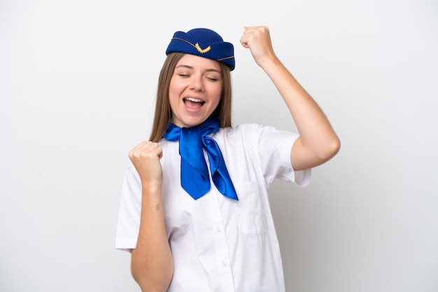 Airplane Lithuanian woman stewardess isolated on white background celebrating a victory