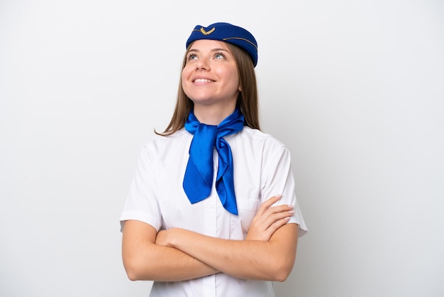 Airplane Lithuanian woman stewardess isolated on white background looking up while smiling