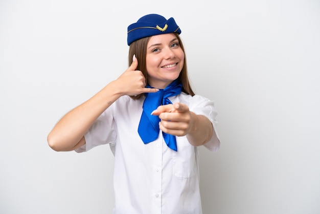 Airplane Lithuanian woman stewardess isolated on white background making phone gesture and pointing front