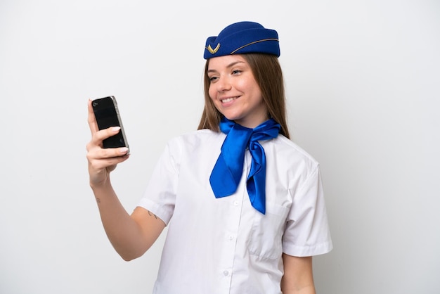 Selfie を作る白い背景で隔離の飛行機リトアニアの女性スチュワーデス