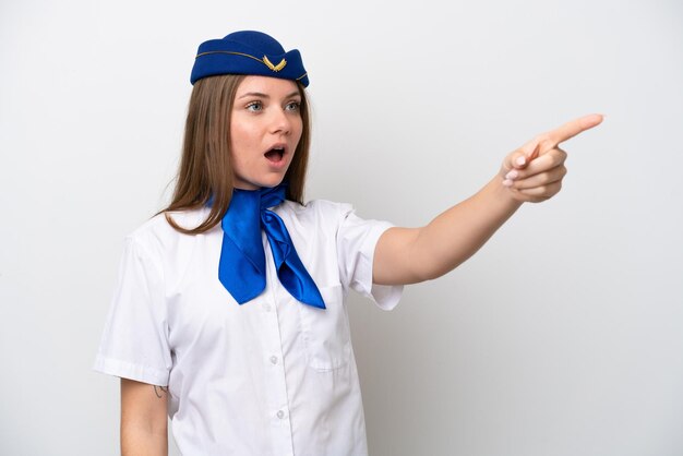 Airplane Lithuanian woman stewardess isolated on white background pointing away