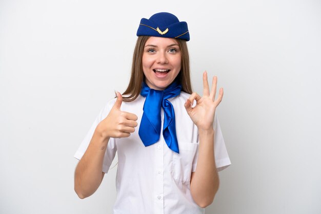 Airplane Lithuanian woman stewardess isolated on white background showing ok sign and thumb up gesture