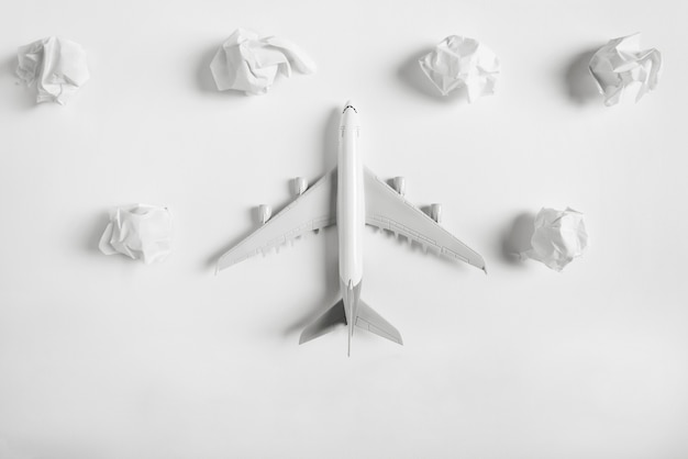 Airplane model flying among paper clouds